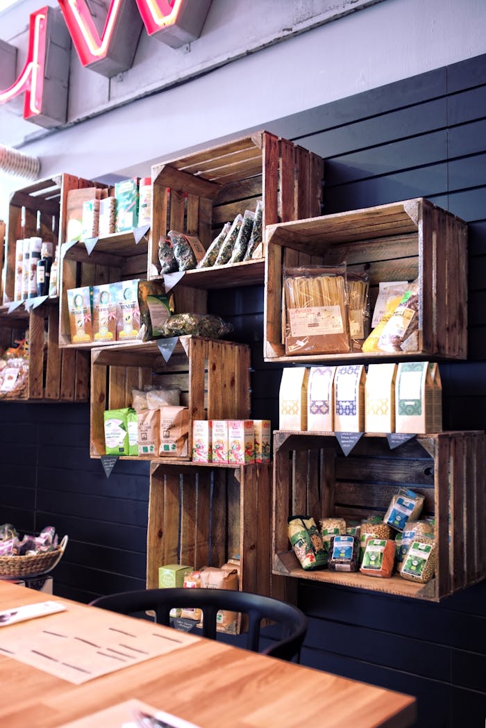 Eco-friendly wooden shelves display organic products in a trendy urban cafe.